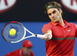 Federer of Switzerland hits a return to Kudryavtsev of Russia during their men's singles match at the Australian Open tennis tournament in Melbourne